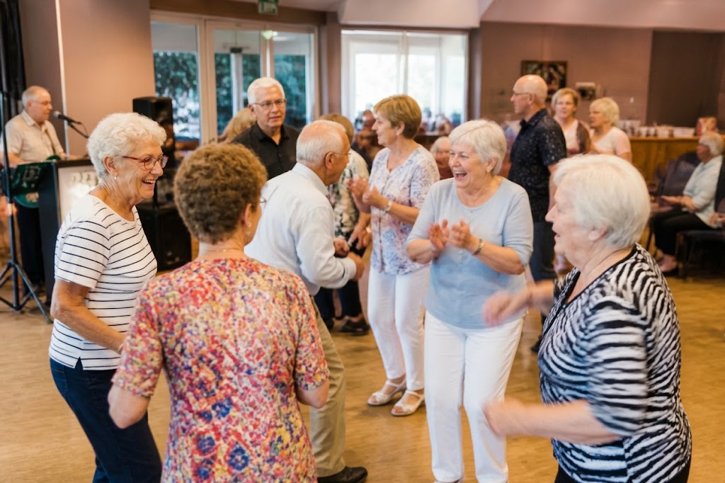 Older adults dancing together at a community senior center