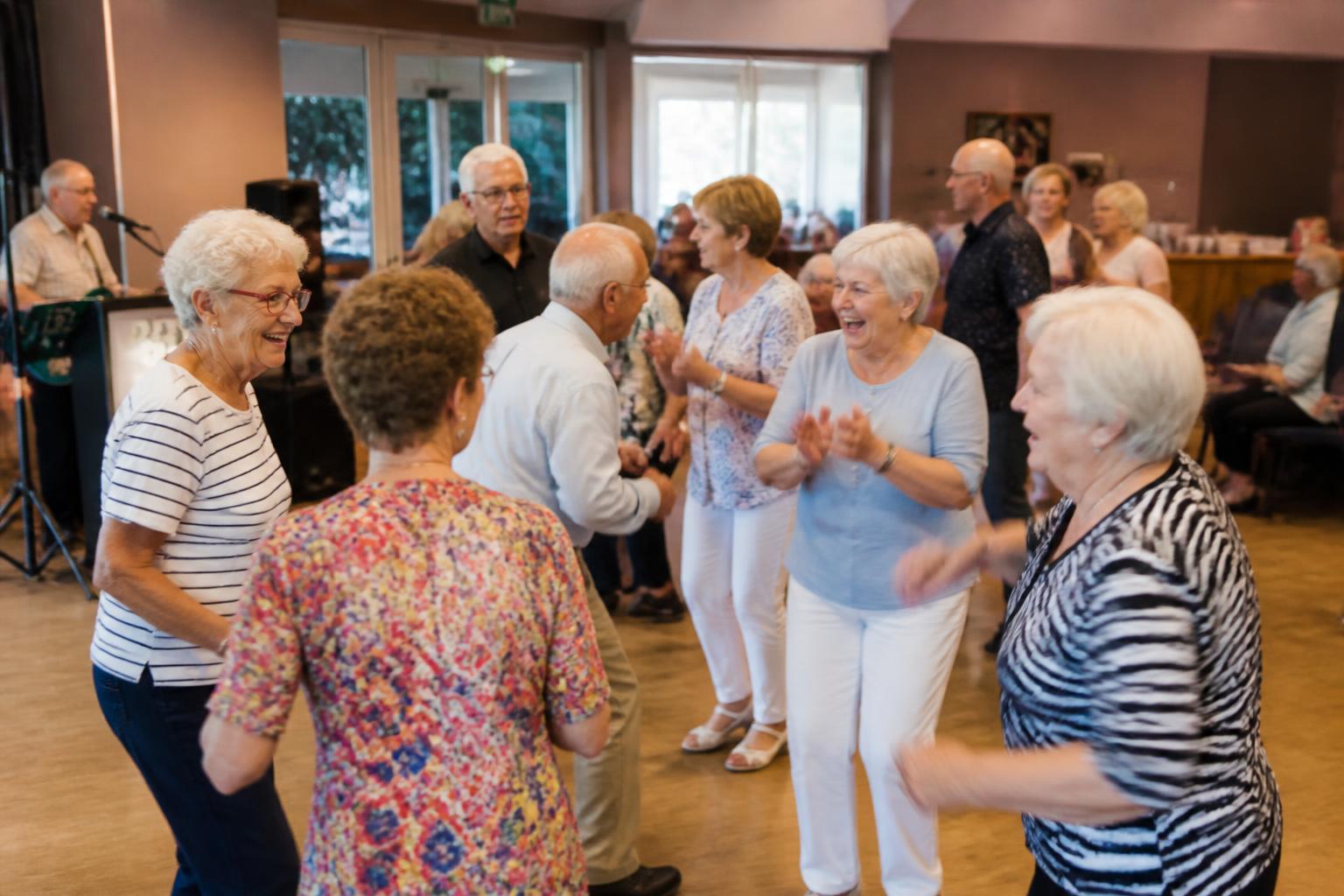 Older adults dancing together at a community senior center